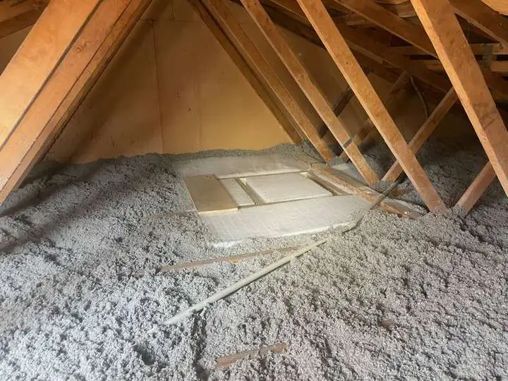 Pale grey cellulose insulation evenly covering a ceiling with a neat protective shroud around the manhole access — Sunnybank