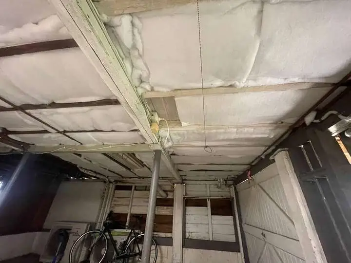 White polyester insulation batts fitted between the joists under a raised timber floor — Moorooka